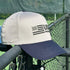 Beige and navy cap with 'USA Pickleball' logo on a metal railing.